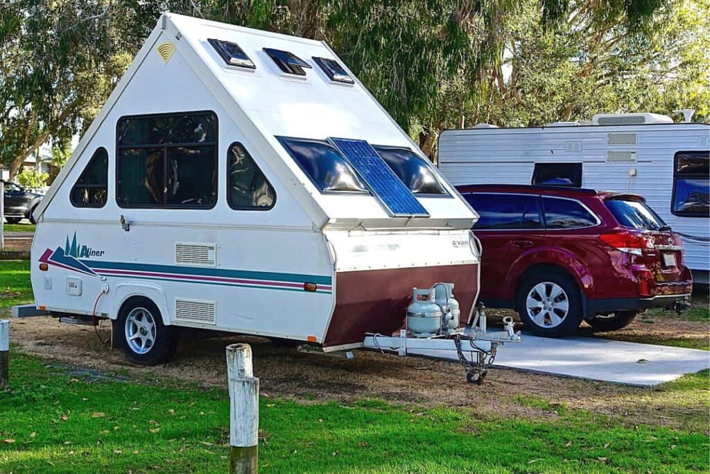Aliner Hard-sided Pop-up Camper Parked at a Campsite