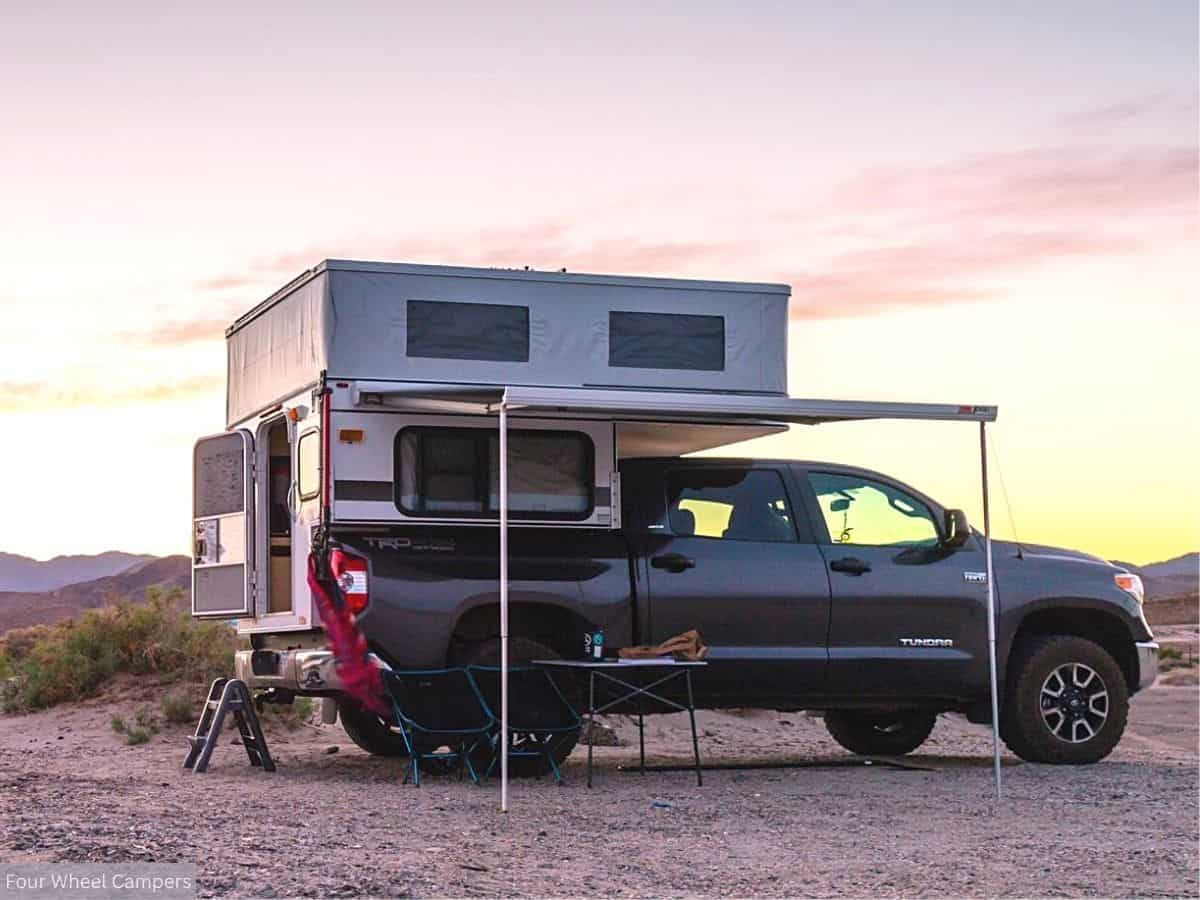 Toyota Tundra with a Truck Camper in the Bed, Set Up in a Remote Desert Location During Dusk
